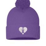 A purple beanie with a pompom on top. The beanie features a white heart with the silhouette of a purple awareness ribbon in the middle.